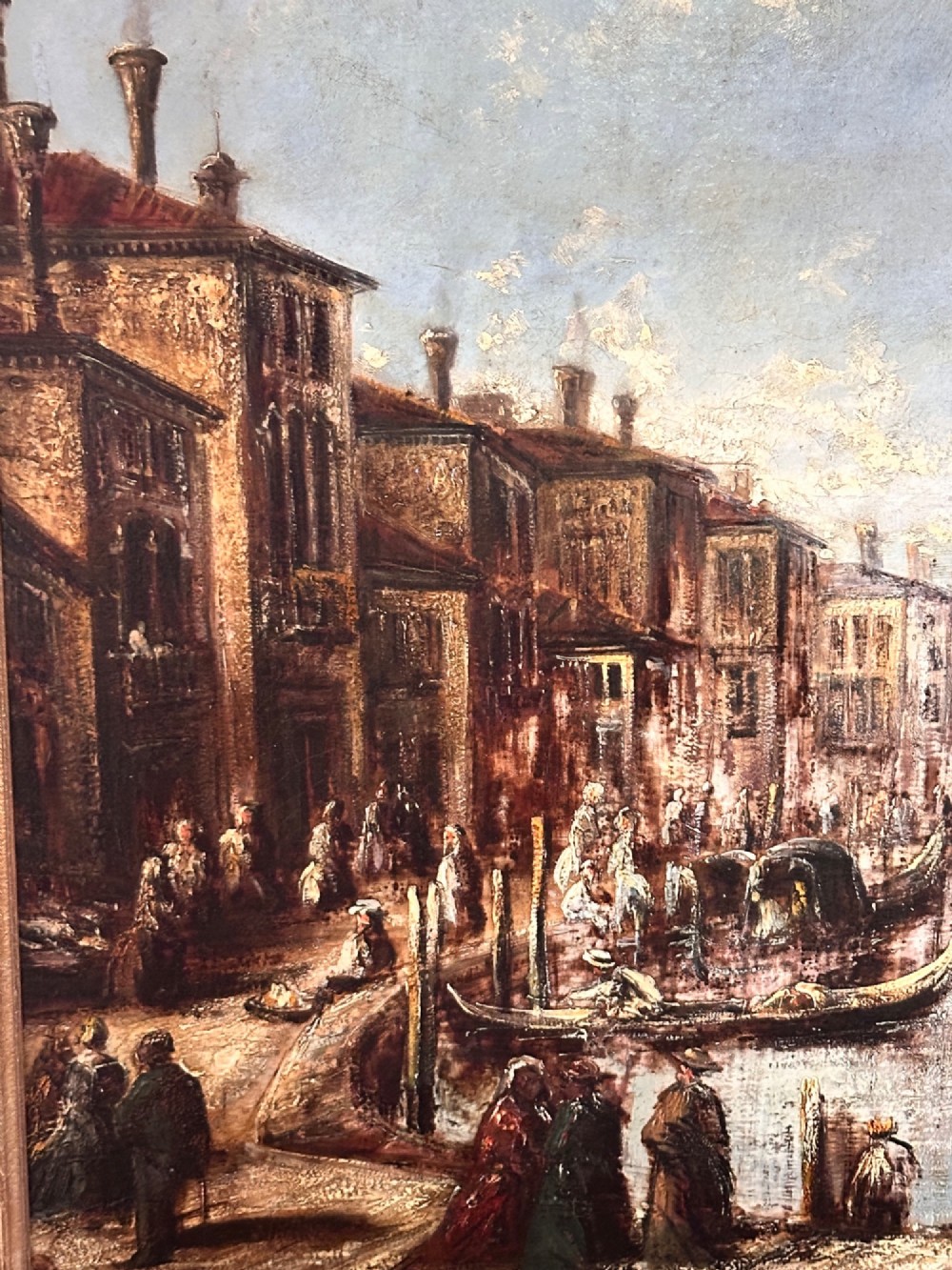An antique oil painting depicting a Venetian canal with gondolas and historical buildings under a cloudy sky, enclosed in an ornate gold frame. View III
