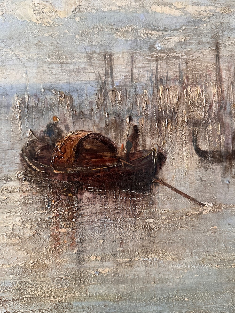 An antique oil painting depicting a Venetian canal with gondolas and historical buildings under a cloudy sky, enclosed in an ornate gold frame. View VI