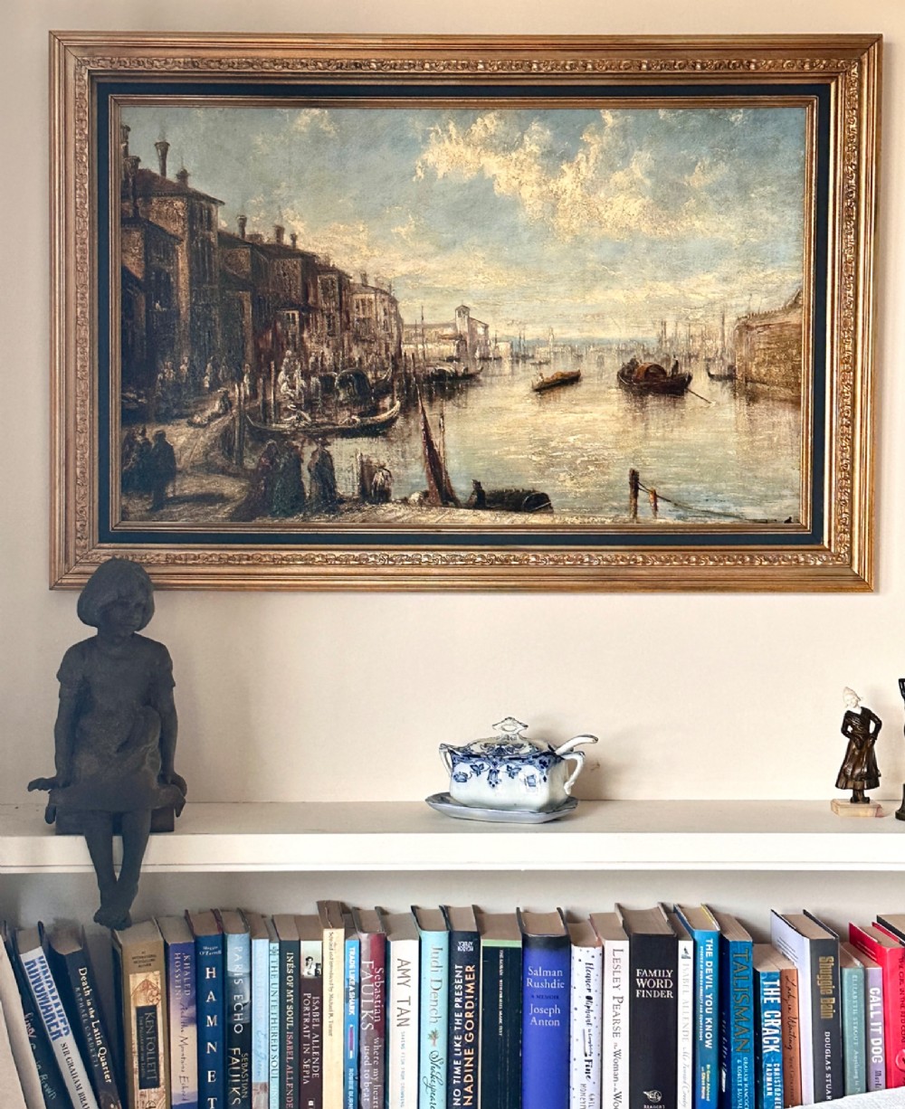 An antique oil painting depicting a Venetian canal with gondolas and historical buildings under a cloudy sky, enclosed in an ornate gold frame. View VIII