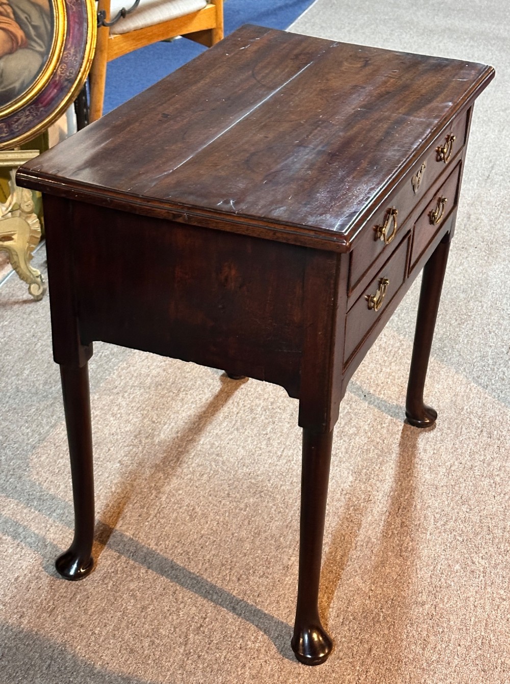 A George III mahogany lowboy featuring three brass-handled drawers, shaped aprons, and slender legs ending in pad feet. View VI