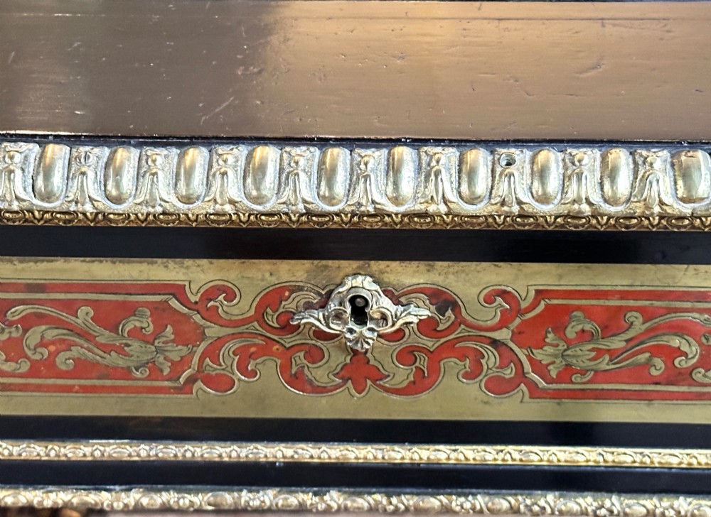 An ebonised French pedestal desk featuring red tortoiseshell and brass Boulle marquetry inlay, multiple drawers, a leather writing top, and a brass gallery. View VIII