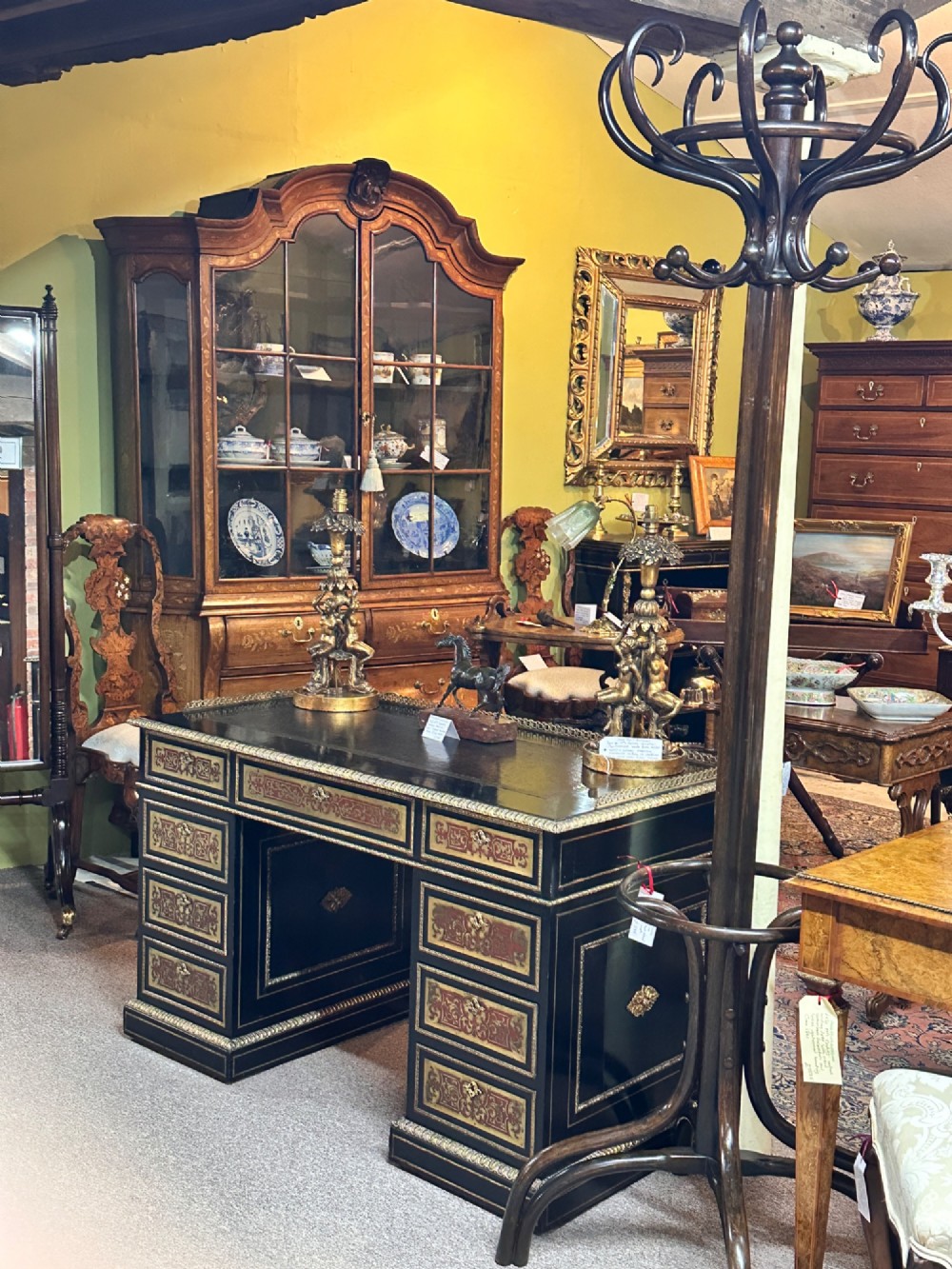 An ebonised French pedestal desk featuring red tortoiseshell and brass Boulle marquetry inlay, multiple drawers, a leather writing top, and a brass gallery. View XV