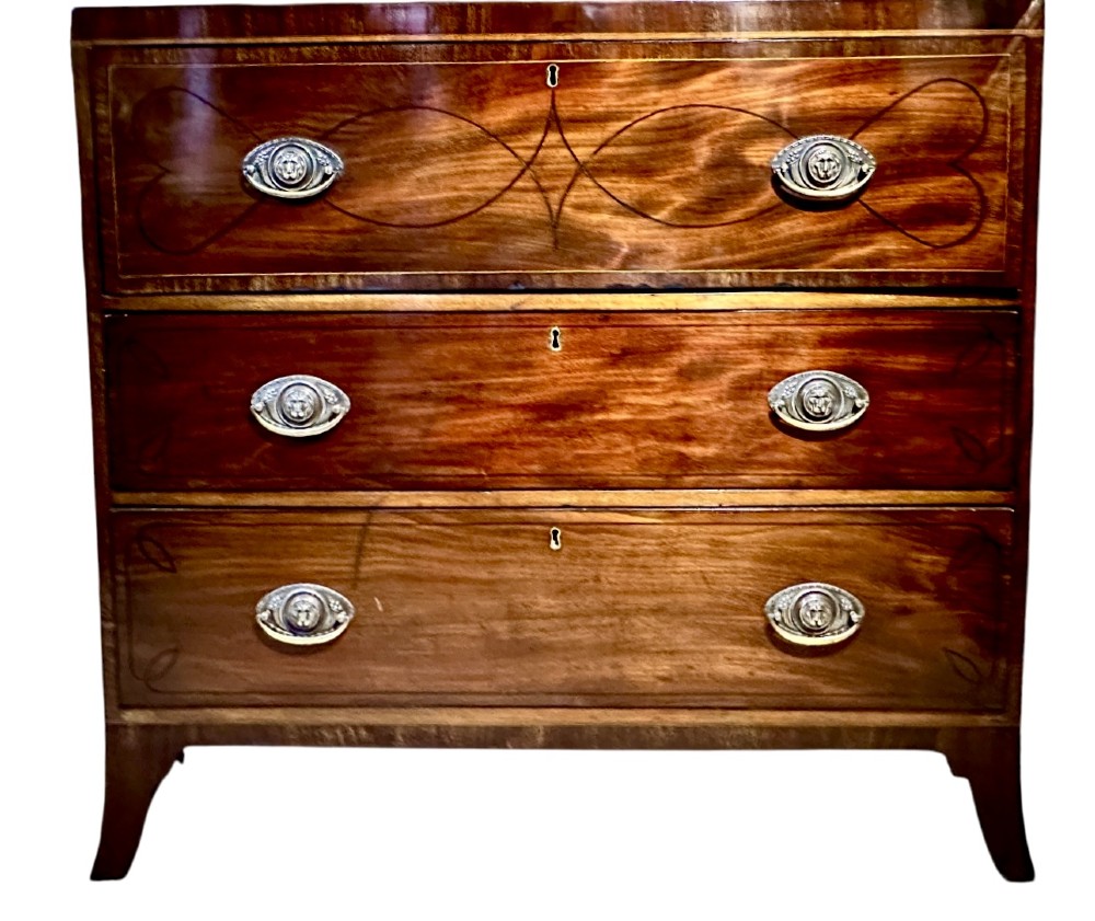 An antique Regency mahogany secretaire bookcase featuring an upper two-door glazed cabinet above a lower chest of drawers with decorative inlay and brass oval drop handles. View VII