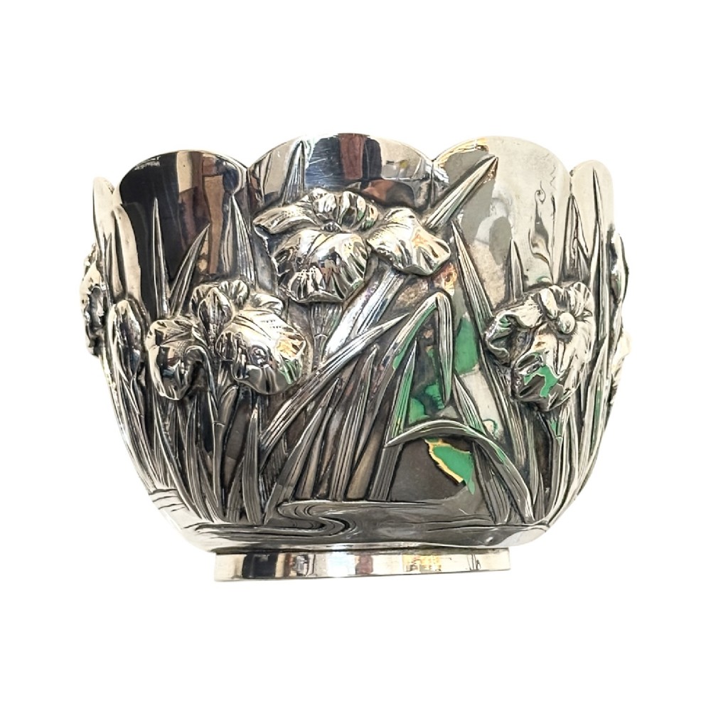 An antique Japanese silver bowl featuring high-relief repousse iris motifs and a scalloped lobed rim. View VI