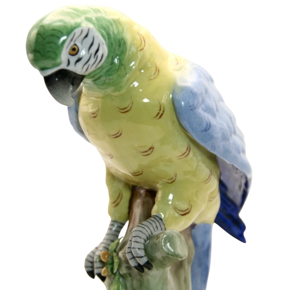 A pair of brightly painted Sitzendorf porcelain parrot figurines perched on textured tree stump bases with leaf accents. View V