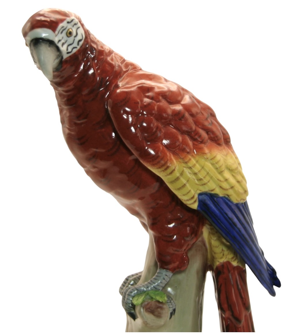 A pair of brightly painted Sitzendorf porcelain parrot figurines perched on textured tree stump bases with leaf accents. View VI