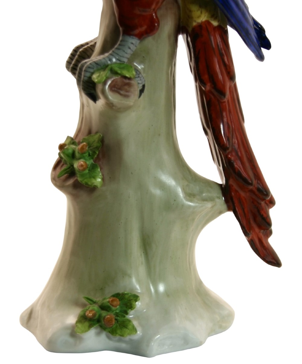 A pair of brightly painted Sitzendorf porcelain parrot figurines perched on textured tree stump bases with leaf accents. View VII