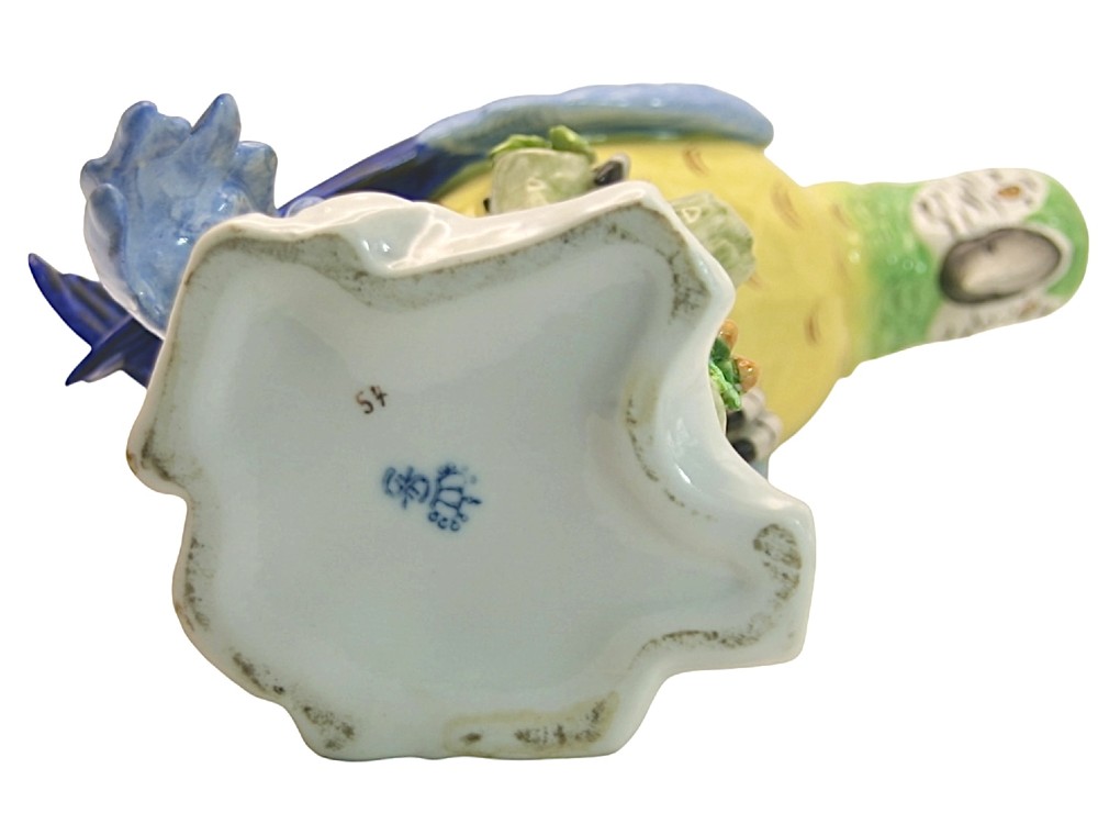 A pair of brightly painted Sitzendorf porcelain parrot figurines perched on textured tree stump bases with leaf accents. View IX