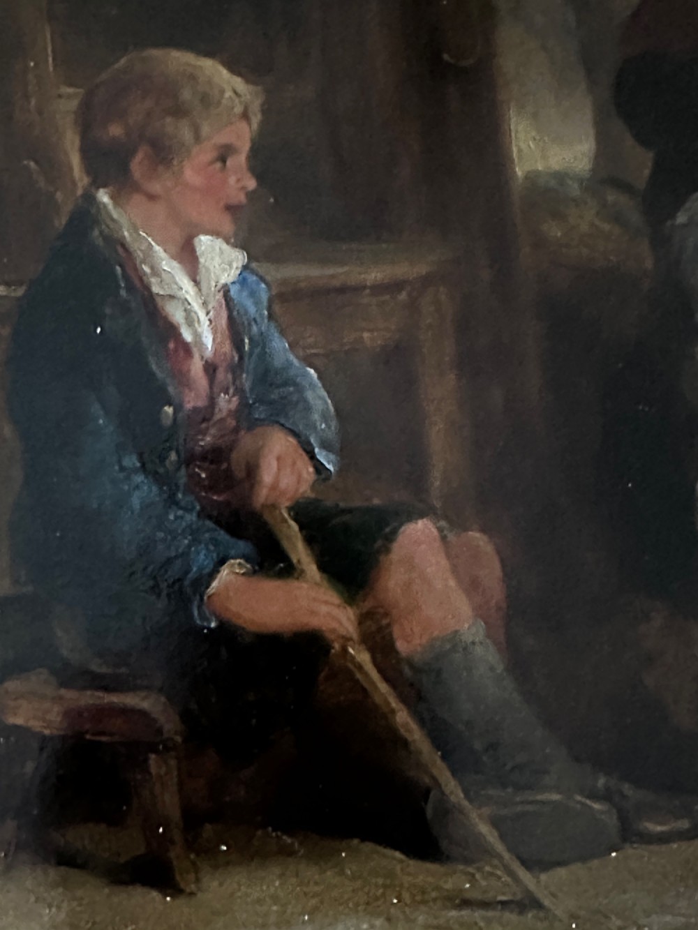A framed Victorian oil painting depicting a rustic cottage interior with children gathered around an open hearth fire. View IV