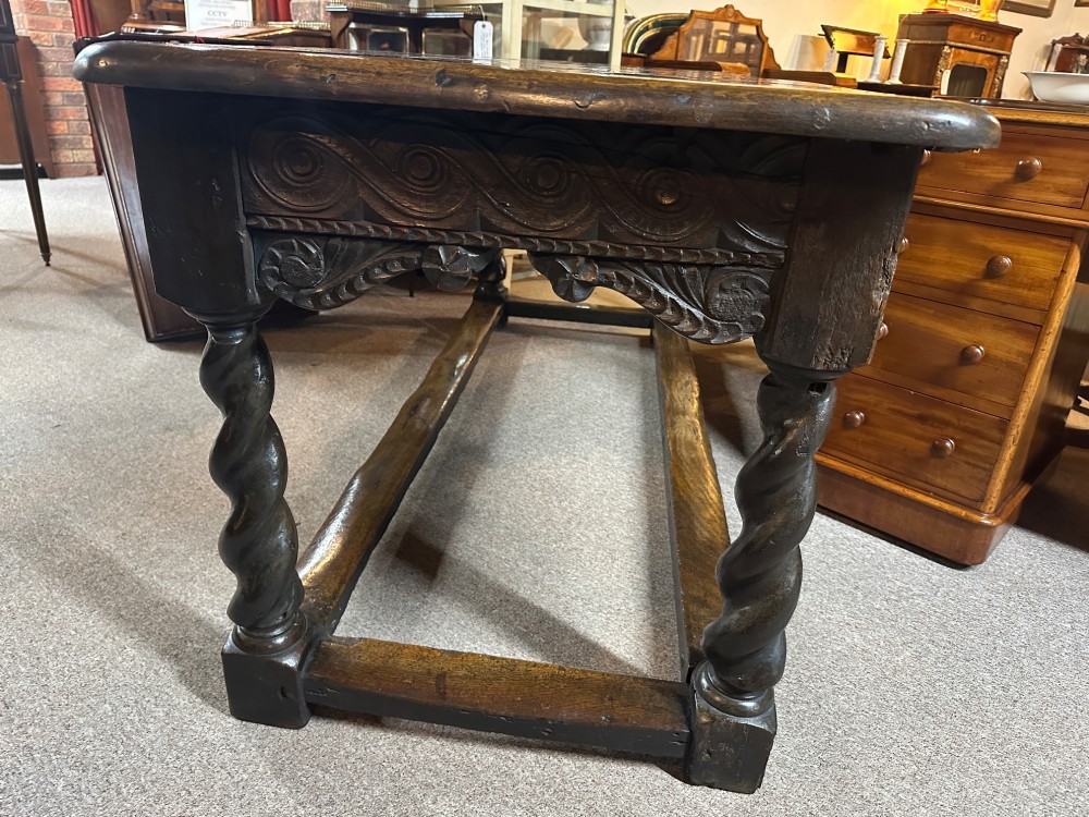 An 18th-century dark oak refectory table featuring carved apron details, spiral barley twist legs, and a perimeter stretcher base. View IV
