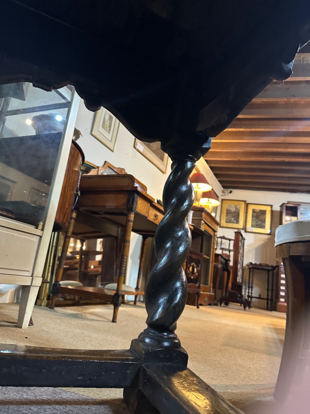 An 18th-century dark oak refectory table featuring carved apron details, spiral barley twist legs, and a perimeter stretcher base. View VI