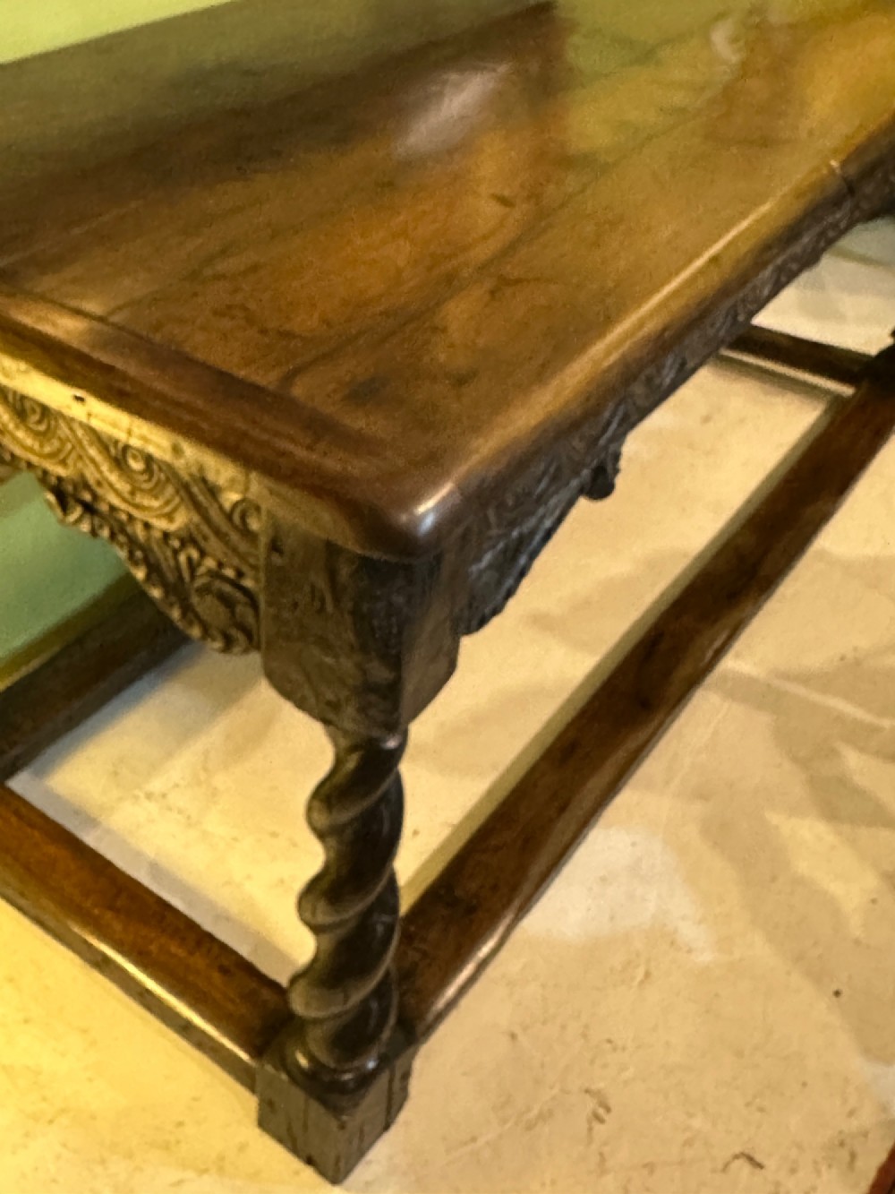 An 18th-century dark oak refectory table featuring carved apron details, spiral barley twist legs, and a perimeter stretcher base. View IX
