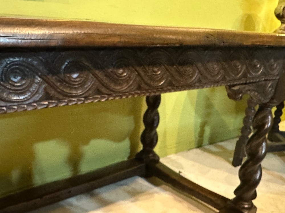 An 18th-century dark oak refectory table featuring carved apron details, spiral barley twist legs, and a perimeter stretcher base. View XII