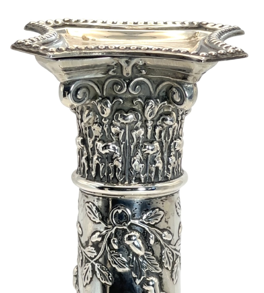 A pair of polished silver column candlesticks featuring Corinthian capitals, foliate swags, and stepped beaded bases. View VIII