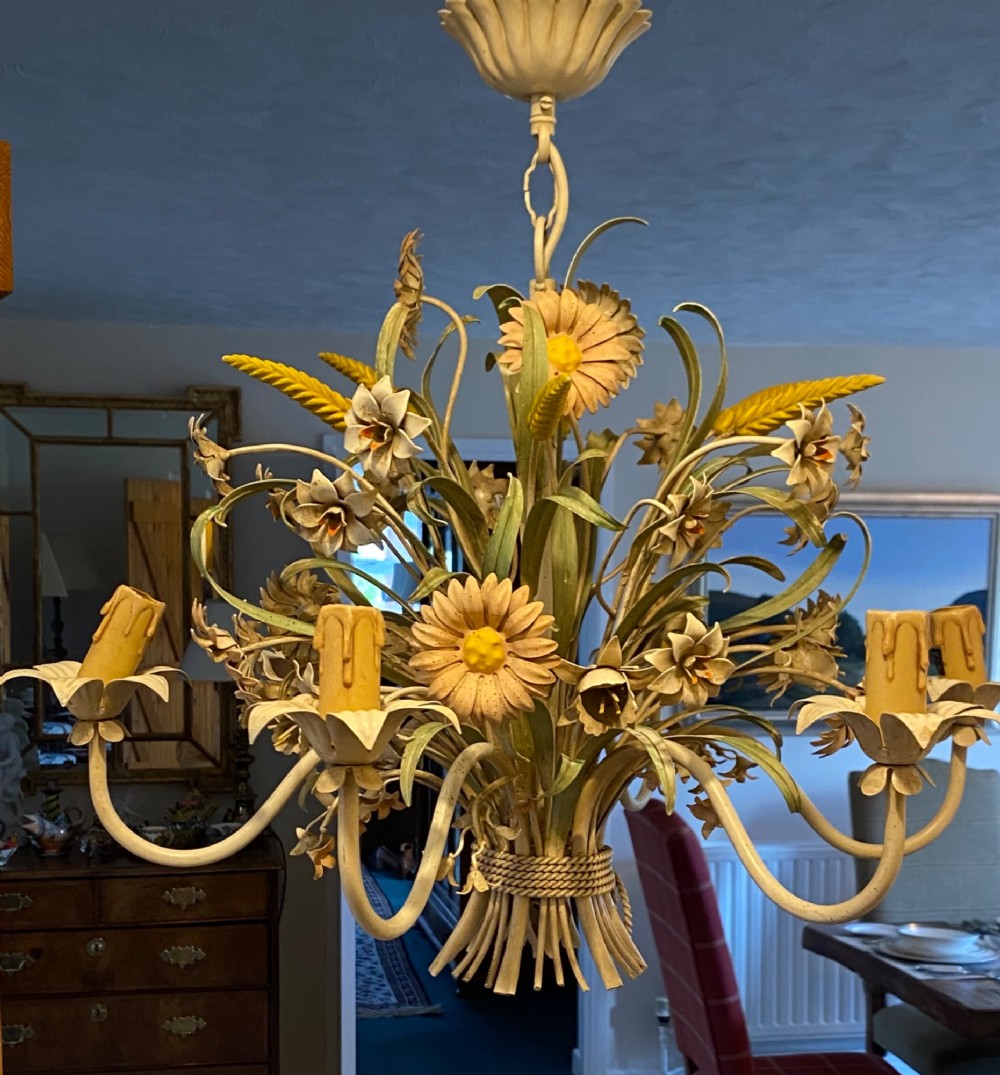 A pair of Italian painted metal toleware chandeliers featuring branching candle arms surrounded by sculpted painted foliage, wheat sheaves, and flowers. View III