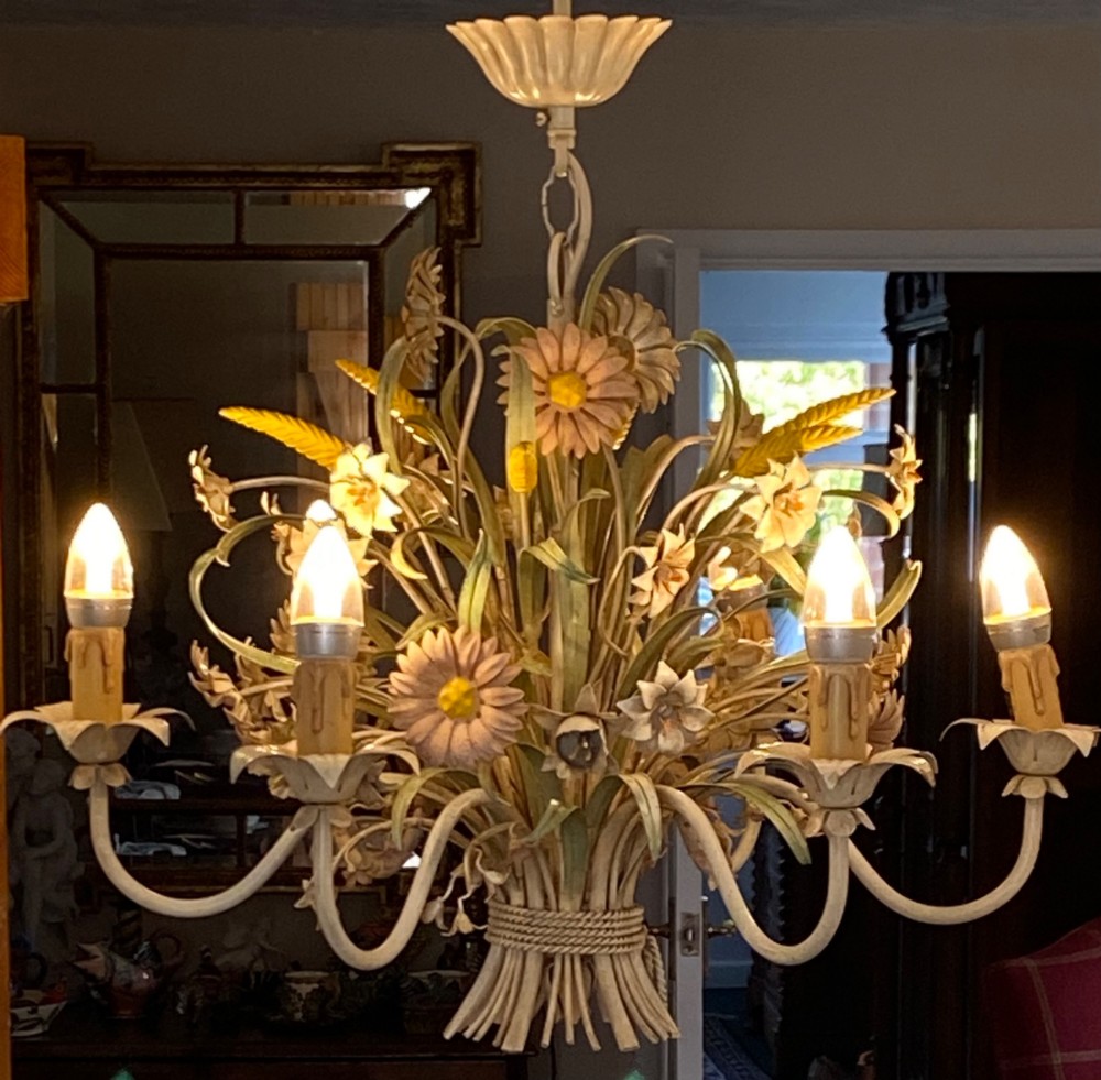 A pair of Italian painted metal toleware chandeliers featuring branching candle arms surrounded by sculpted painted foliage, wheat sheaves, and flowers. View V