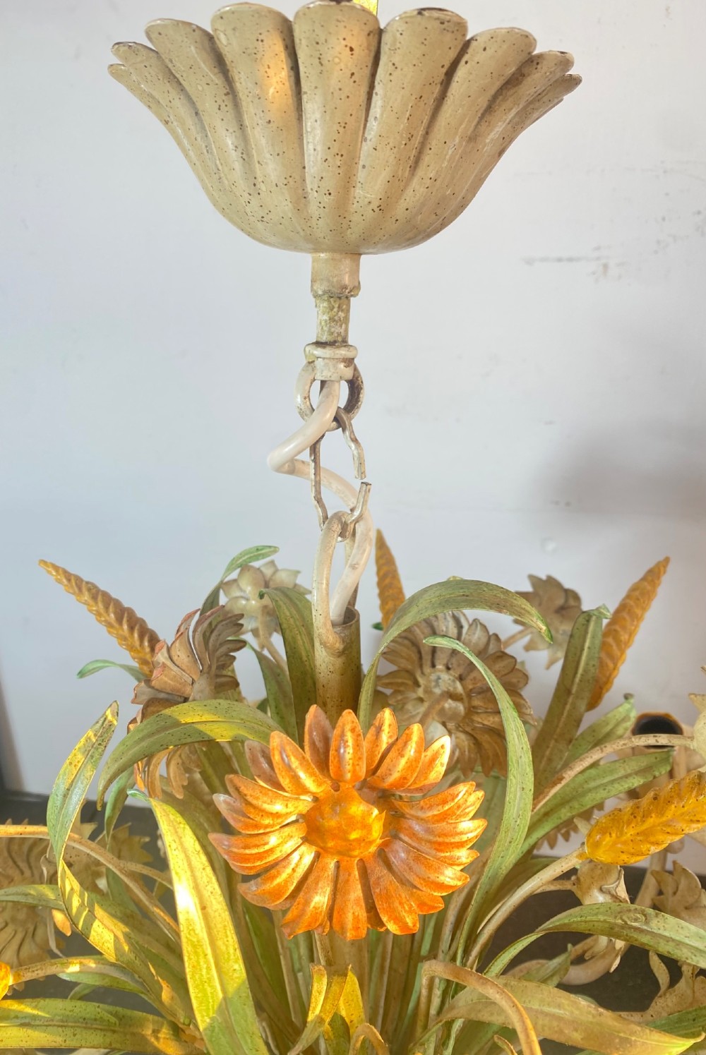 A pair of Italian painted metal toleware chandeliers featuring branching candle arms surrounded by sculpted painted foliage, wheat sheaves, and flowers. View XI