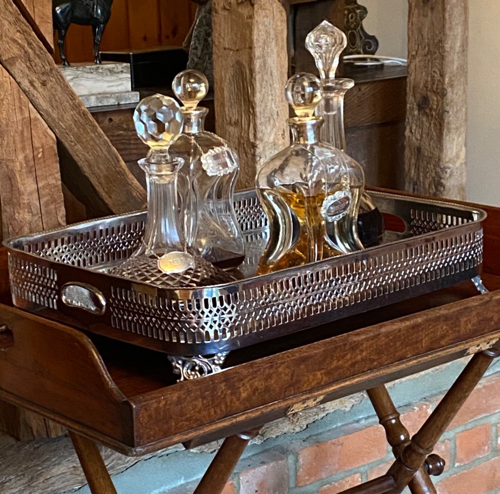 A rectangular silver-plated gallery tray featuring pierced fretwork sides, integrated oval hand-holds, an engraved surface, and ornate scrolled feet. View III
