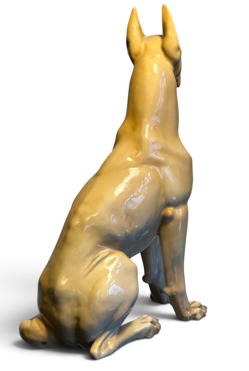 A glazed fawn-coloured Nymphenburg porcelain figurine depicting a seated Great Dane with erect ears and a black muzzle. View III