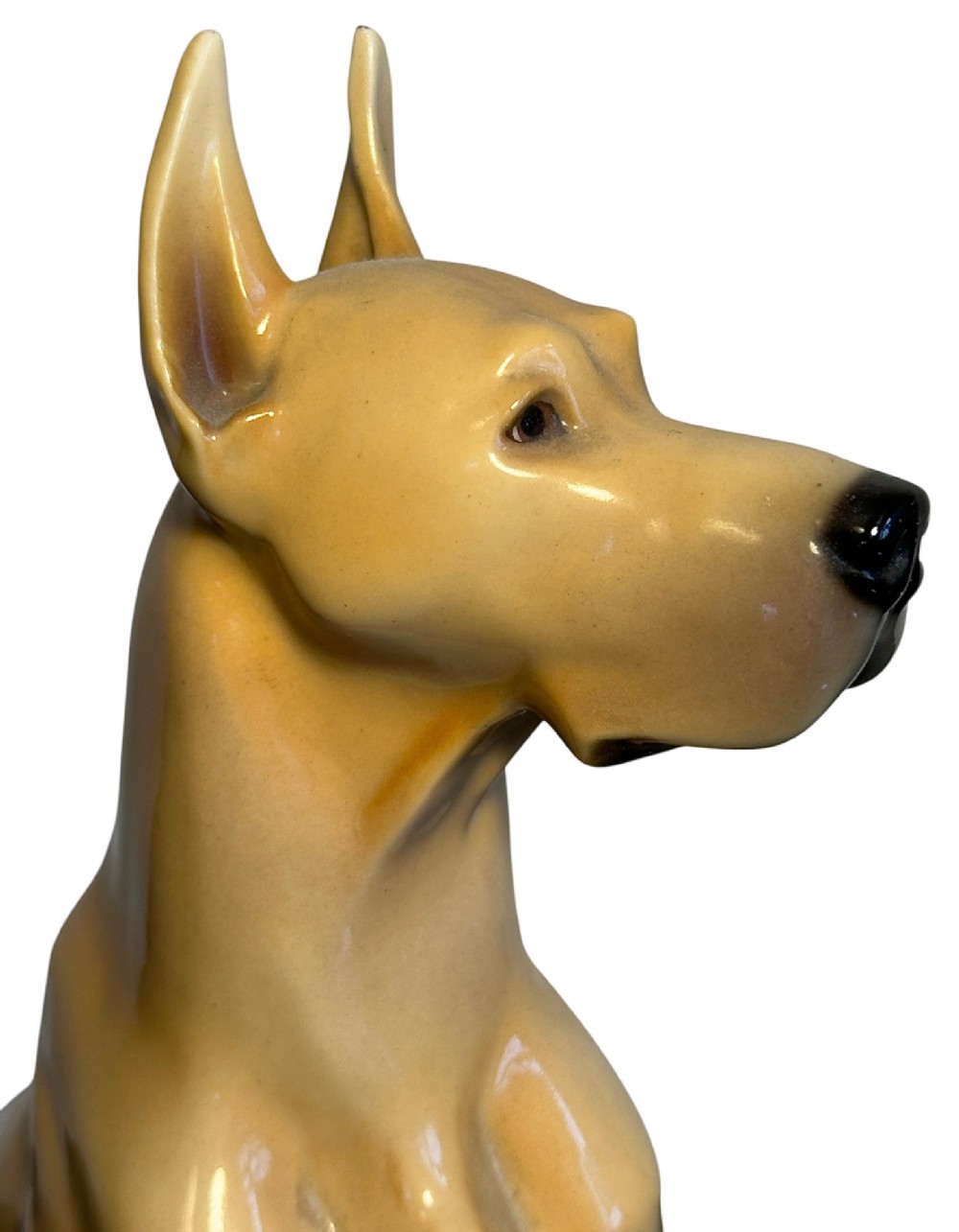A glazed fawn-coloured Nymphenburg porcelain figurine depicting a seated Great Dane with erect ears and a black muzzle. View VI