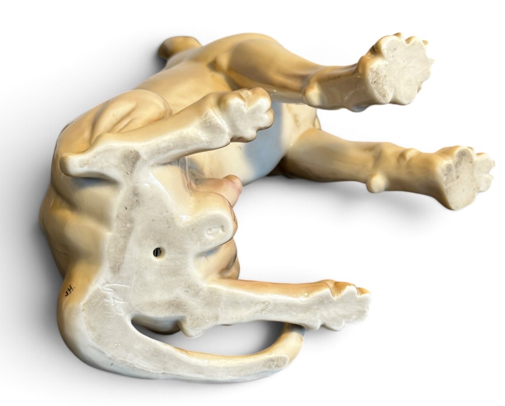 A glazed fawn-coloured Nymphenburg porcelain figurine depicting a seated Great Dane with erect ears and a black muzzle. View VIII