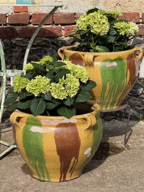 A PAIR OF 'DRIBBLE GLAZED' CASTELNAUDARY PLANTERS FROM THE SOUTH OF FRANCE