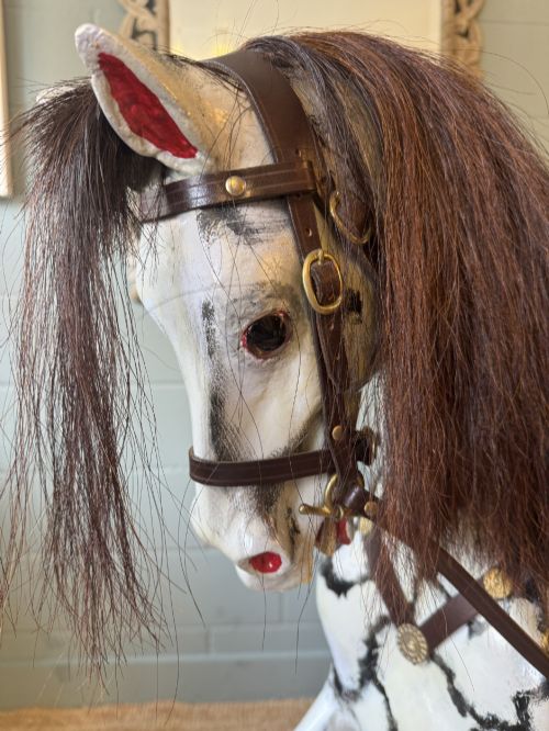 fig 1. An Edwardian carved wooden dapple grey rocking horse with real horsehair and leather saddle, mounted on a black painted wooden bow rocker.