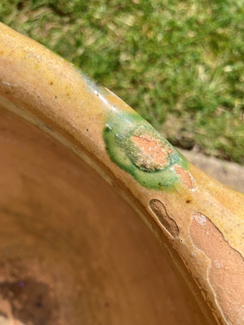 A pair of round ochre yellow terracotta planters featuring green and brown drip glaze patterns and twin looped side handles. View III