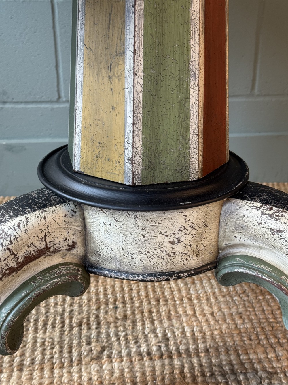 A Victorian circular tilt-top table featuring a hand-painted swirling polychrome petal pattern across its surface, resting on a distressed carved tripod base. View VI