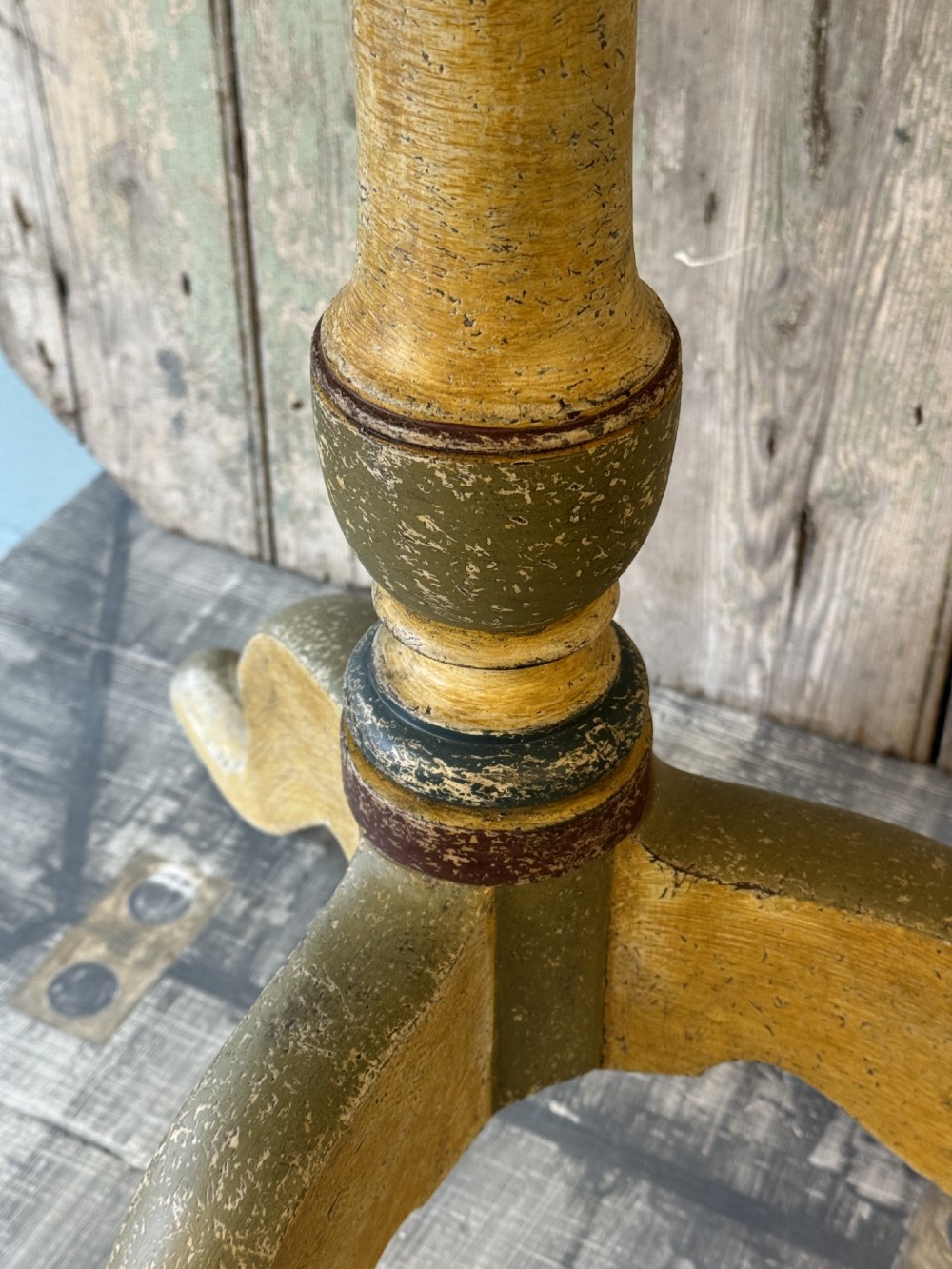 A Victorian three-tier wooden pedestal table with a painted finish, turned central stem, starburst motif, and tripod feet. View VIII