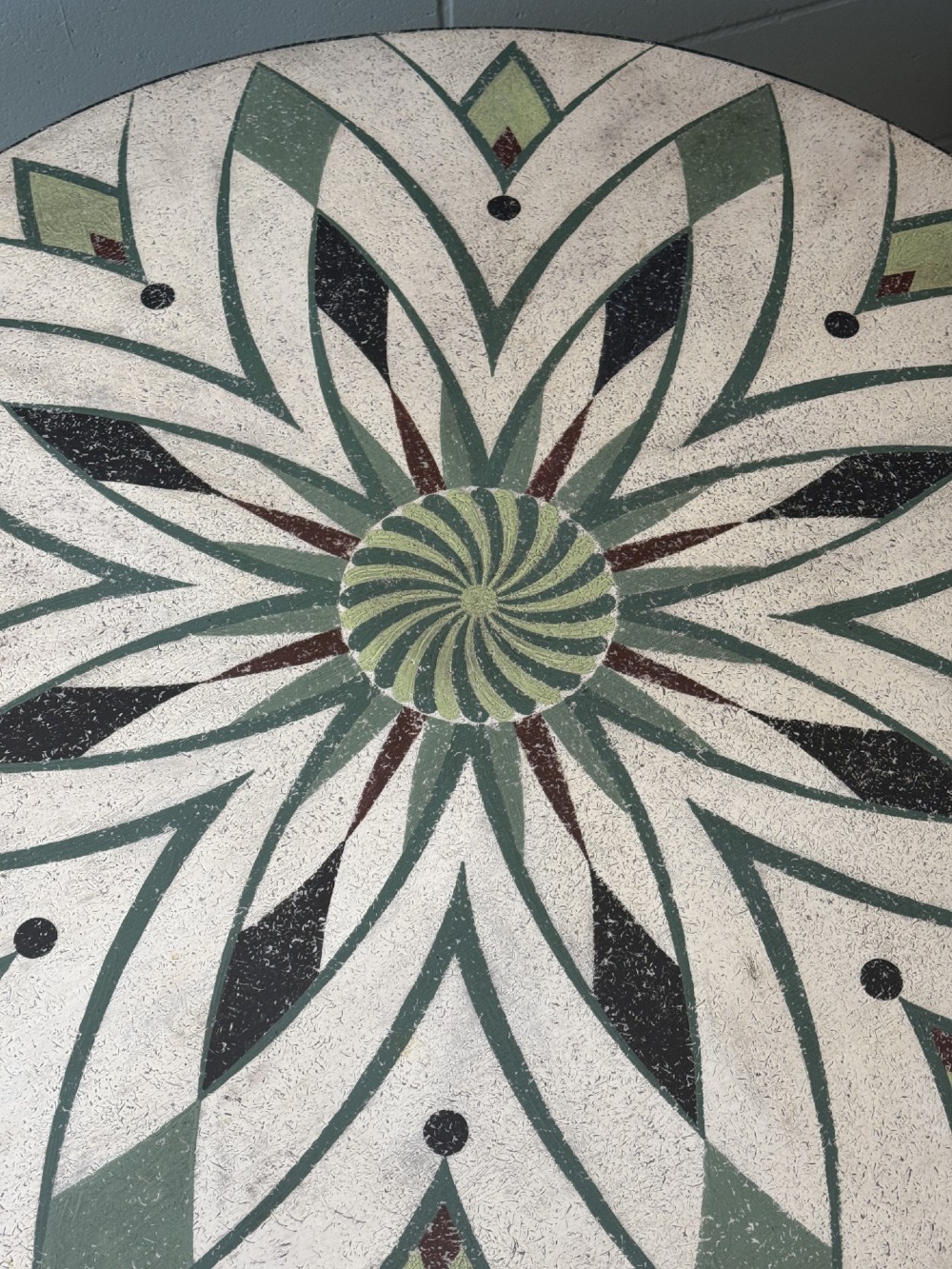 A Victorian circular tilt-top table with a turned tripod pedestal base and hand-painted geometric petal design in green, cream, and black. View III