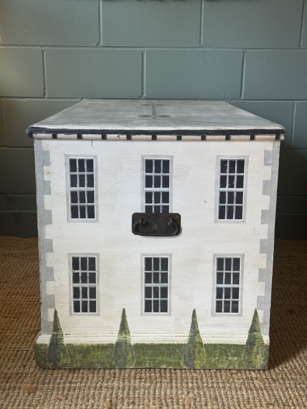 An off-white wooden blanket box hand-painted with a detailed depiction of a Georgian manor house facade featuring a central red door, sash windows, and stone steps. View IV