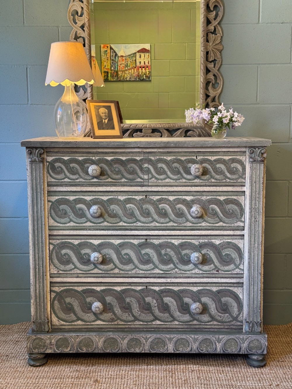 A grey-green hand-painted French Empire chest of drawers featuring guilloche drawer decoration, fluted pilasters, and side cartouche panels. View II