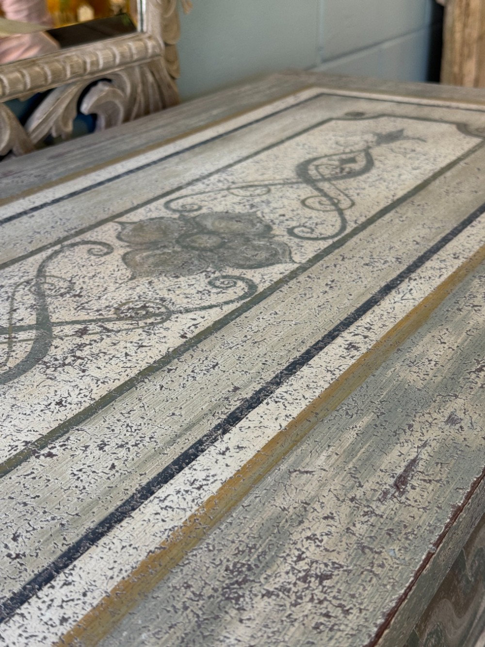 A grey-green hand-painted French Empire chest of drawers featuring guilloche drawer decoration, fluted pilasters, and side cartouche panels. View VI