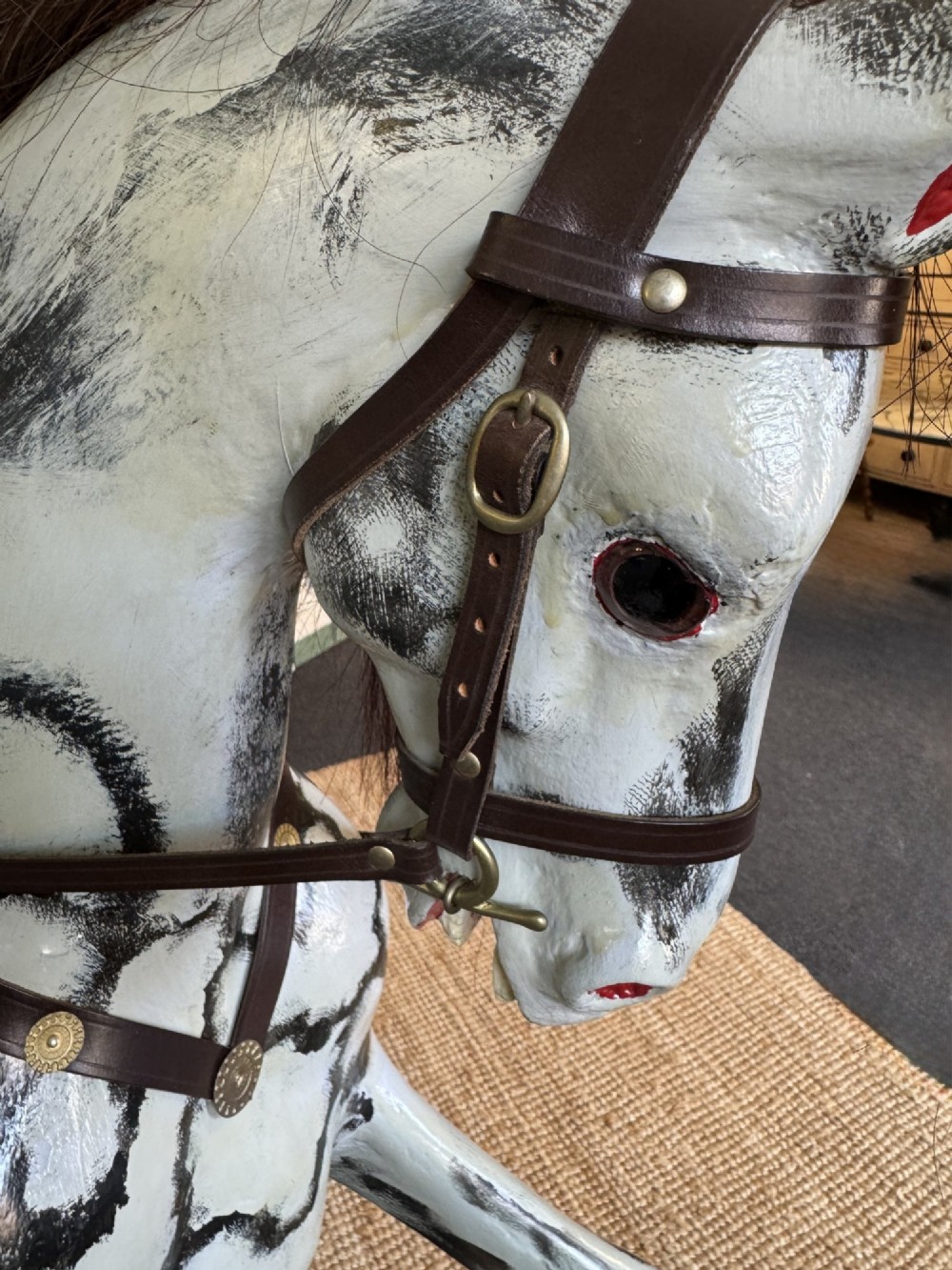 An Edwardian carved wooden dapple grey rocking horse with real horsehair and leather saddle, mounted on a black painted wooden bow rocker. View V