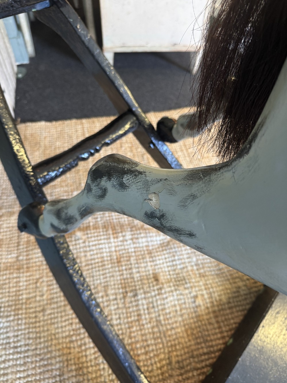 An Edwardian carved wooden dapple grey rocking horse with real horsehair and leather saddle, mounted on a black painted wooden bow rocker. View XII