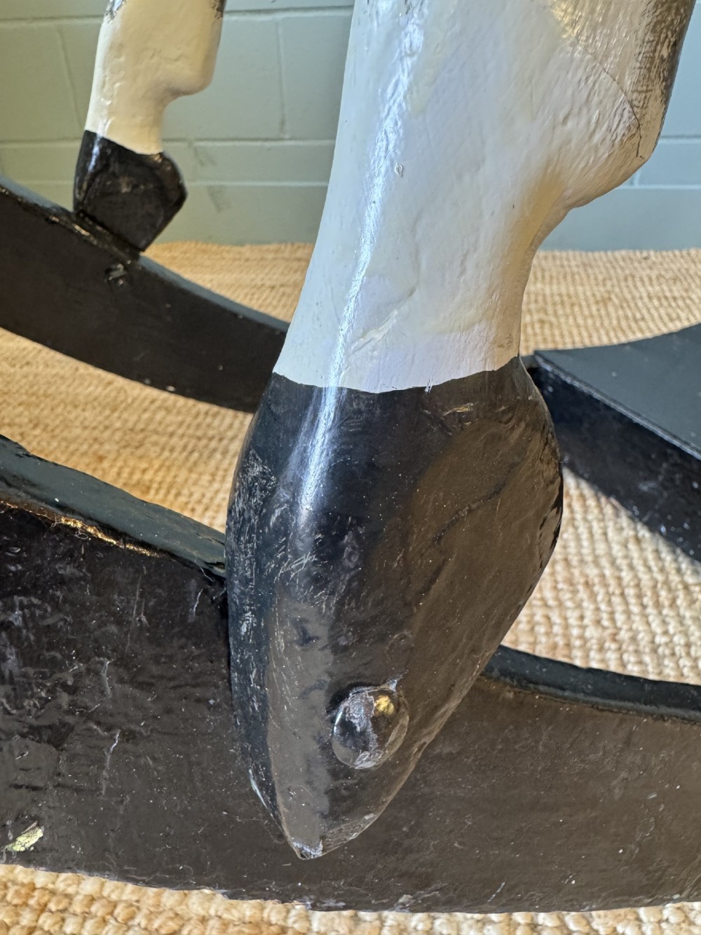 An Edwardian carved wooden dapple grey rocking horse with real horsehair and leather saddle, mounted on a black painted wooden bow rocker. View XIV