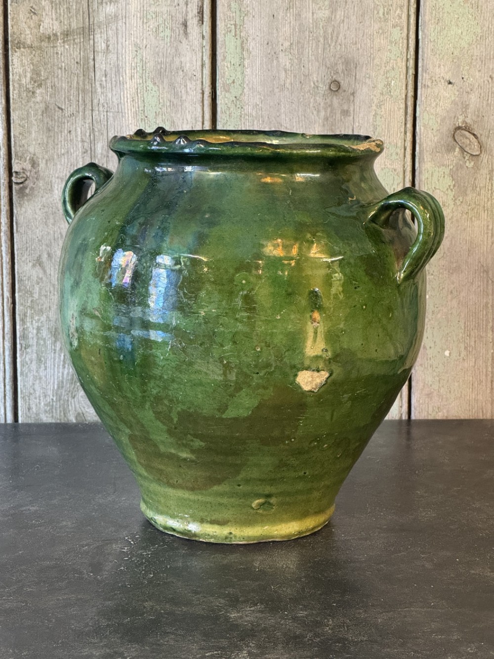 A 19th-century French green glazed earthenware confit pot featuring dual side handles and a scalloped rim. View II