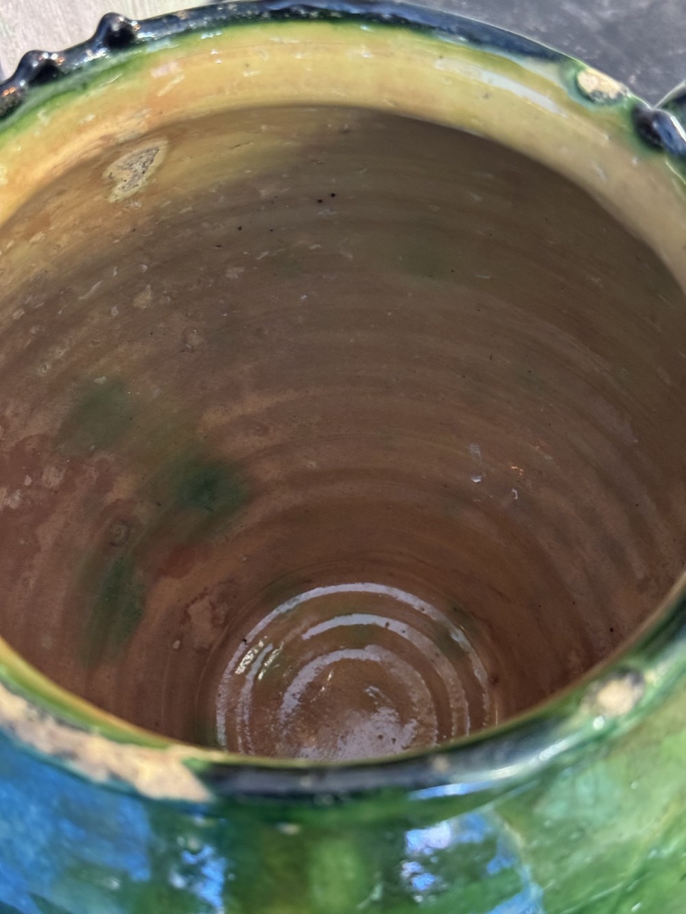 A 19th-century French green glazed earthenware confit pot featuring dual side handles and a scalloped rim. View V