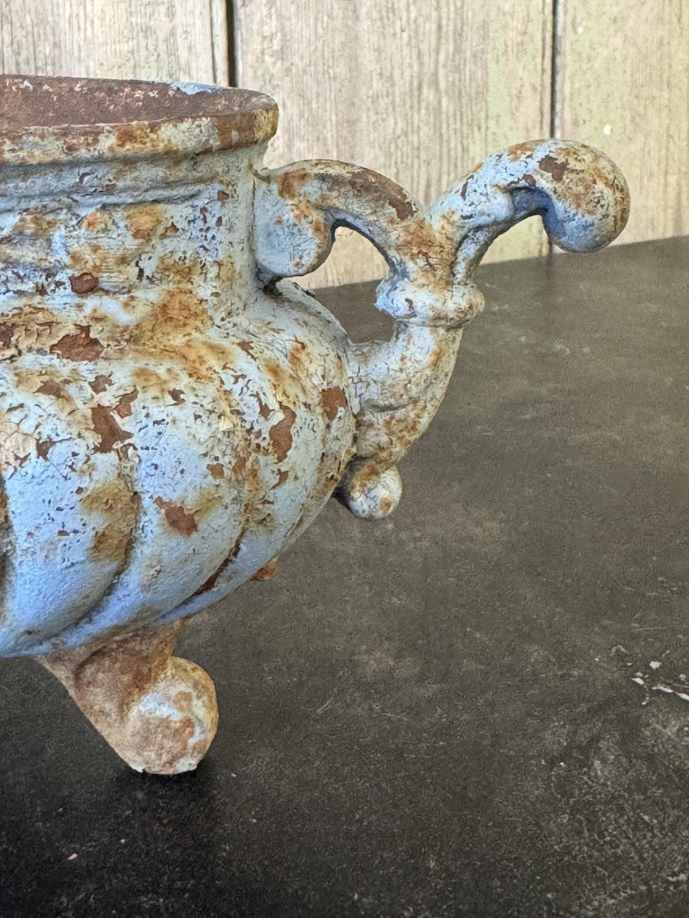 A 19th-century French cast iron jardiniere with fluted details, twin scroll handles, and a distressed pale blue painted surface finish. View II