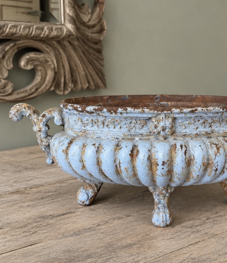 A 19th-century French cast iron jardiniere with fluted details, twin scroll handles, and a distressed pale blue painted surface finish. View VII