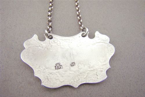 fig 2. GEORGE II ESCUTCHEON WHITE WINE LABEL BY JOHN HARVEY, LONDON CIRCA 1740