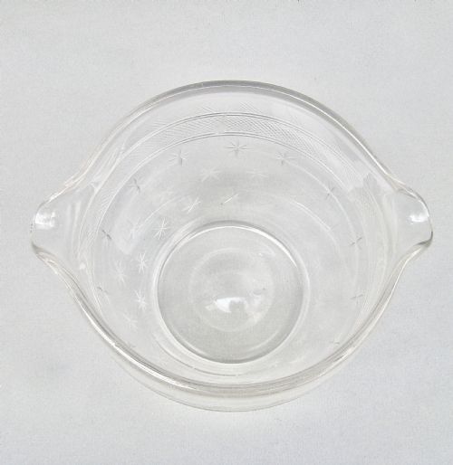 fig 1. A clear late 18th-century Georgian glass rinser featuring twin pouring spouts, a diamond-cut waistband, and starburst motifs etched around the lower bowl.