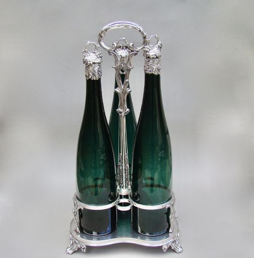 fig 2. SET OF THREE VICTORIAN BRISTOL GREEN GLASS DECANTER BY HENRY WILKINSON & CO, BIRMINGHAM 1839 IN THEIR ORIGINAL SILVER PLATED STAND