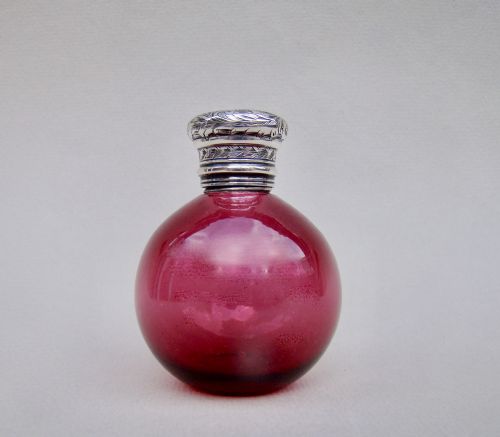 fig 1. SMALL AND EXQUISITE VICTORIAN SILVER AND CRANBERRY GLASS SCENT BOTTLE, CIRCA 1890