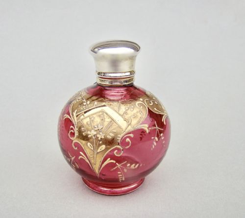 fig 1. VICTORIAN SILVER GILT ENAMELLED CRANBERRY GLASS SCENT BOTTLE, CIRCA 1890