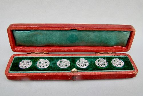 fig 1. A cased set of six Art Nouveau pierced sterling silver buttons arranged inside a red velvet-lined fitted box.