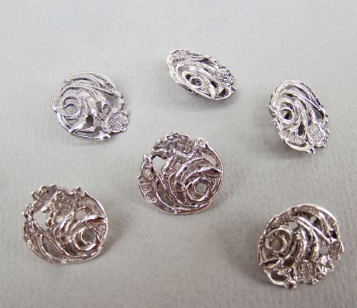 fig 2. A cased set of six Art Nouveau pierced sterling silver buttons arranged inside a red velvet-lined fitted box.