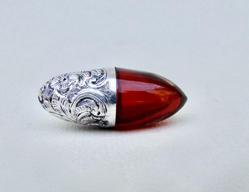 fig 1. RARE VICTORIAN SILVER AND CRANBERRY GLASS BULLET SHAPED SCENT BOTTLE, CIRCA 1890