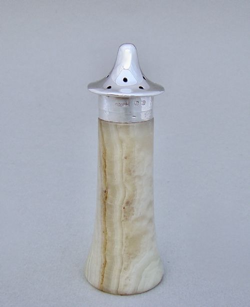 fig 1. An Edwardian silver-mounted agate pepper pot featuring a carved stone base with a hallmark-stamped sterling silver collar and perforated cap.